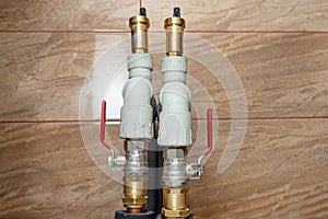 Two open three-quarter inch valves installed in the heat pump installation, plastic elbows visible.