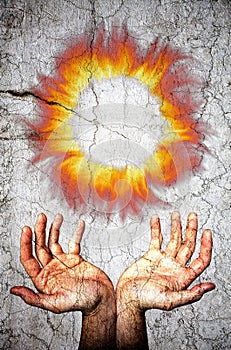 Two opened hands upwards and fire flames crown. Crack marble surface.