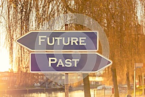 Two opposing signs with the words future and past as motivational aid