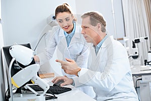 two opticians working with computer