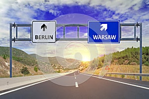 Two options Berlin and Warsaw on road signs on highway