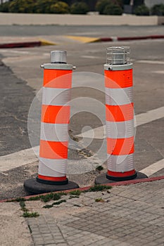 Two orange construction barricades on the street