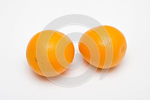 Two orange fruit on white backgrounds