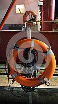 Two orange life preservers hung for use