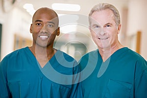 Two Orderlies Standing In A Hospital Corridor