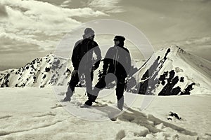 Two other tourists on the snow-capped mountain top