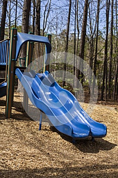 Two outdoor blue children\'s playground slides