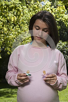 Two pacifiers in mum hands photo