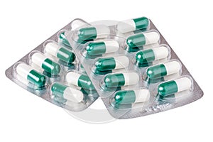 Two packages with red green yellow pills on white background