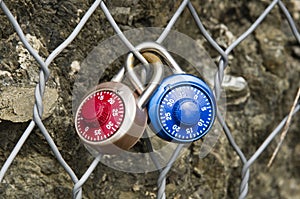 Two Padlocks Combination closed on a metal grid