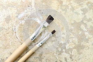 Two paintbrushes on the dirty floor