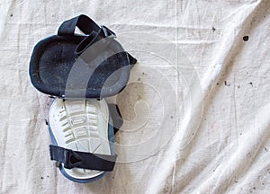 Two painter`s kneepads on a drop cloth