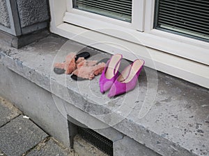 two pair of shoes left on the windowsill