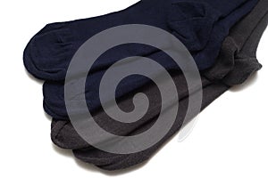 Two pairs of black and dark brown bamboo socks against a white backdrop