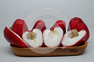 two pairs of fresh cut Malay apple served on wooden tray