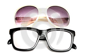 Two pairs of glasses sunshades sunglasses with black frame framing