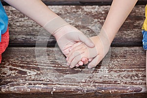 Two pairs of hand touching each other