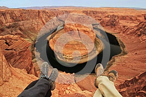 Two pairs of legs at Horseshoe bend overlook