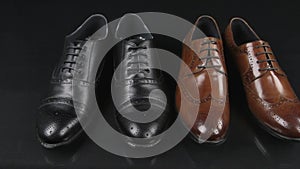 Two pairs of men`s classic shoes with laces. Slider shot.