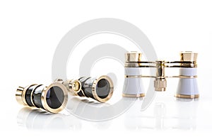 Two Pairs of opera glasses on a white background