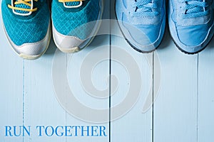 Two pairs of running sneakers on blue background