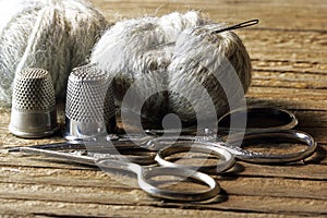 TWO PAIRS OF SCISSORS WITH GREY DARNING YARN A NEEDLE AND METAL THIMBLE