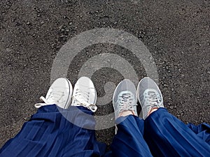 Two pairs of shoes resting on the road