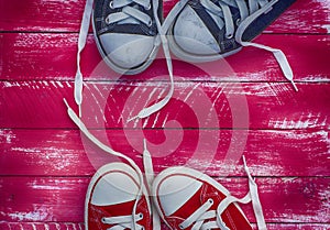 Two pairs of sneakers on a pink background