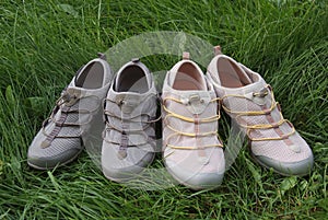 Two pairs of sports shoes In the grass