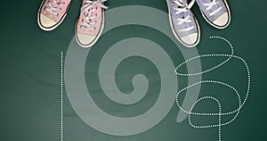 Two pairs of textile sneakers on a green background. The concept of choosing a path is difficult and confusing or straight and