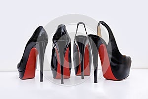 Women's black high-heeled shoes on a white background