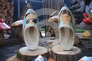 Two pairs of wooden clogs with a male and female depicted on it