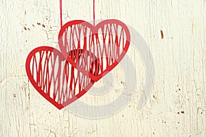 Two paper hearts on a old white wood