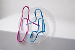 two paperclips sitting on white desk - love concept