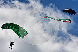 Two parachutes landing from a cloudy sky