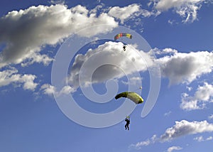 Two Paragliders in the air above the clouds