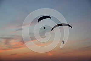 Two paragliders in the dramatic sky