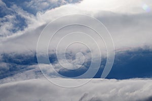 Two parallel clouds blue sky .