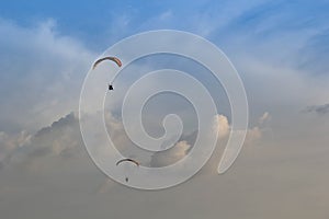 Two Paramotor flying on the blue sky