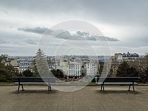 Two park benches and a view over Paris