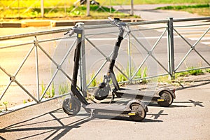 Two parked electric scooters, a sports vehicle, transportation.