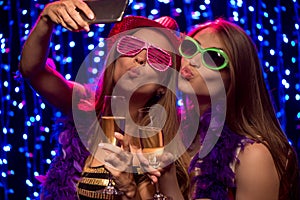 Two party girls with glasses of shampagne