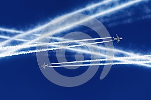 Two passenger airplanes met at altitude and were crossed by courses aviation airport contrail clouds.