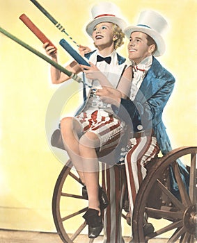 Two patriotic people with Roman candles celebrating July 4th