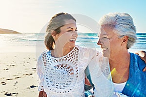 Two peas in a pod. a senior woman and her adult daughter spending a day at the beach.