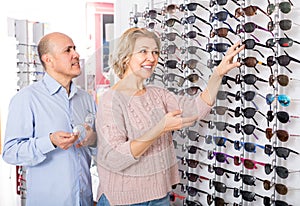 Two pensioners choosing sunglasses