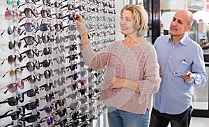 Two pensioners choosing sunglasses