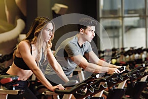 Couple in a spinning class wearing sportswear. photo