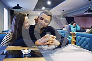 Two people in cafe enjoying the time spending with each other. Toned. Selective focus.