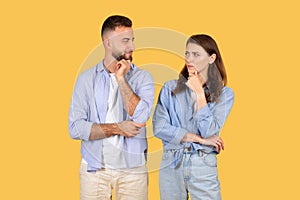 Two people contemplating with hand on chin